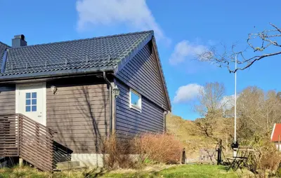 a house with a gambrel roof at 1 Bedroom Amazing Apartment In Stord in Stord