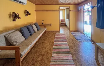 a living room with a long couch in a room at Beautiful Home In Jordet With Sauna in Lybekk
