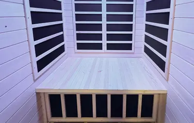 a small sauna with white panels and a wooden bench at Beautiful Home In Jordet With Sauna in Lybekk