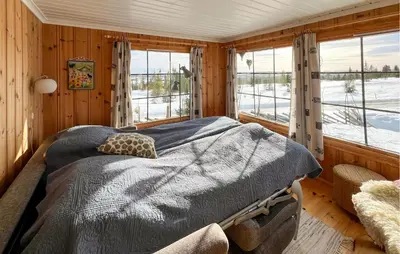 a bedroom with a bed in a room with windows at Beautiful Home In Vang På Hedmarken in Sæli
