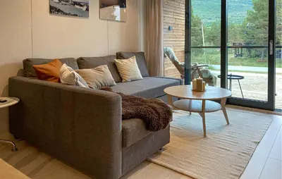 a living room with a couch and a table at 2 Bedroom Gorgeous Home In Bjorli in Bjorli