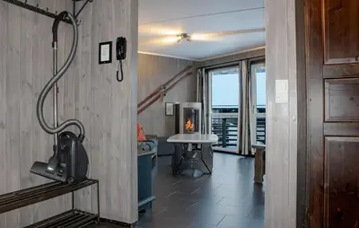 a room with a fireplace and a table with a view at Lovely Apartment In Hemsedal With Sauna in Hemsedal