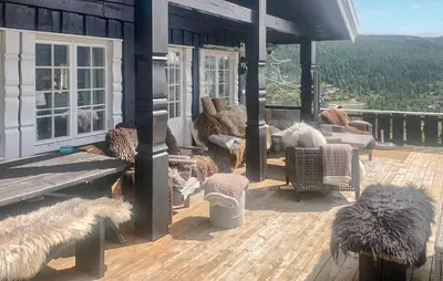 a porch of a house with chairs and windows at Nice Home In Rjukan With Wifi in Rjukan