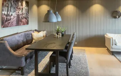 a dining room with a table and a couch at Stunning Apartment In Hovden I Setesdal in Hovden