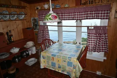 a kitchen with a window and a table with a box at En perle i Trondheimsfjorden in Trondheim