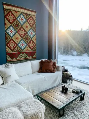 a living room with a couch and a table and a window at Cabin By Heimsila River In Hemsedal in Hemsedal
