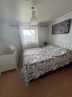 a bedroom with a bed and a window at Utsiken in Bergen