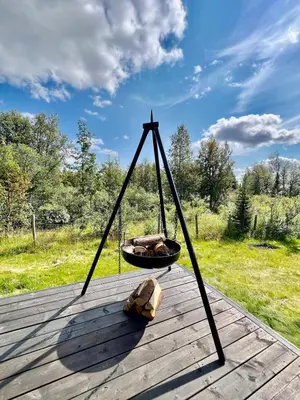 a swing on top of a wooden deck at Traditional mountain cabin in Valdres in Blomstølen