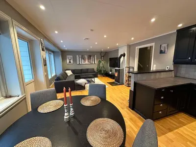 a living room with a table and a couch at Leiligheit i Hornindal in Volda