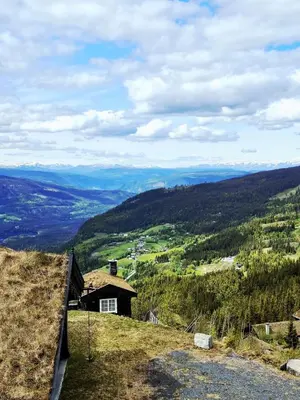 a house on top of a hill with a view at Tømmerhytte i Valdres med panoramautsikt over fjellene in Aurdal