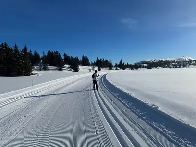 a man is standing on a snow covered road at Tømmerhytte i Valdres med panoramautsikt over fjellene in Aurdal