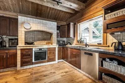 a large kitchen with wooden cabinets and wooden floors at Vacation house in Hemsedal in Hemsedal