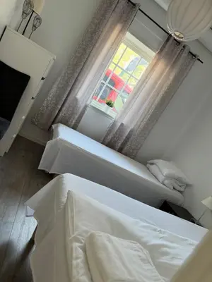 a bedroom with two beds and a window at Sentral fantastisk leilighet in Øvre Årdal