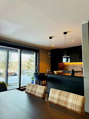a kitchen with a table and chairs and a counter at Geilolie - apartment in Geilo in Geilo