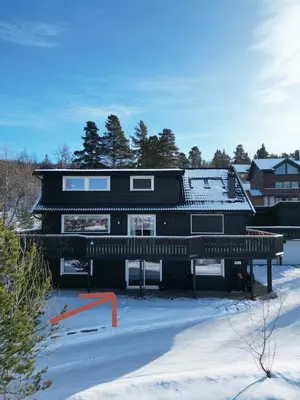 a black house with snow on the ground at Geilolie - apartment in Geilo in Geilo