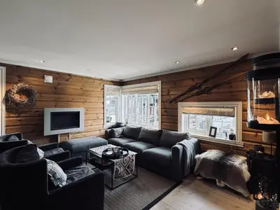 a living room with a couch and a tv at Fully equipped ski-in ski-out apartment at Kikut, Geilo in Geilo