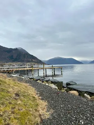 a dock on the shore of a body of water at Live right by the Sognefjord in Sogndal
