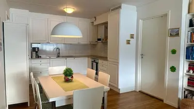 a kitchen with a table with a plant on it at Live right by the Sognefjord in Sogndal