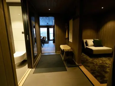 a room with a bathroom with a tub and a couch at Ski in & out - Hemsedal in Kyrkjebøen