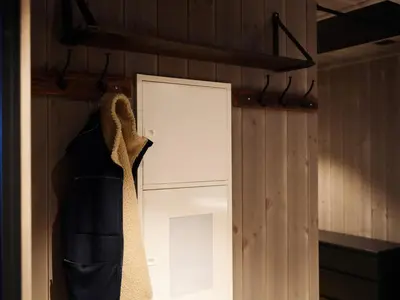 a closet with a tie hanging next to a door at Ski in & out - Hemsedal in Kyrkjebøen