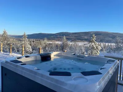 a hot tub covered in snow on a balcony at Veltelia Resort in Nes i Ådal