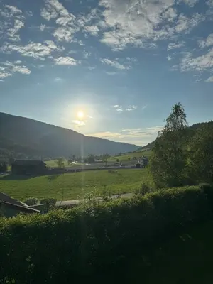 a view of a field with the sun in the sky at Kjellerleilighet in Bjørge