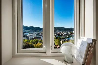 a window with a view of a city at Stay Panorama - Best view in Bergen l 1-Bedroom in Bergen