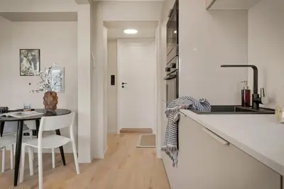 a kitchen with a table and a white counter top at Stay Panorama - Best view in Bergen l 1-Bedroom in Bergen