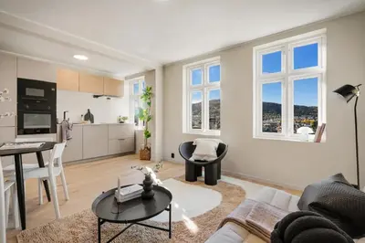 a living room with a couch and a table at Stay Panorama - Best view in Bergen l 1-Bedroom in Bergen