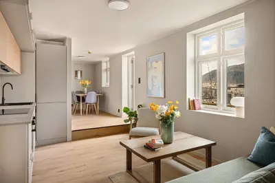 a living room with a couch and a table at Stay Panorama - Best view in Bergen l 2BR & Terrace in Bergen