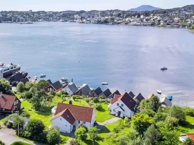 an aerial view of a houses on the shore of a lake at Short way to city centre and Aker Solutions! in Stord