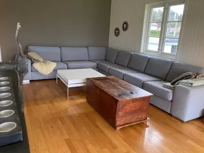 a living room with a couch and a coffee table at Short way to city centre and Aker Solutions! in Stord
