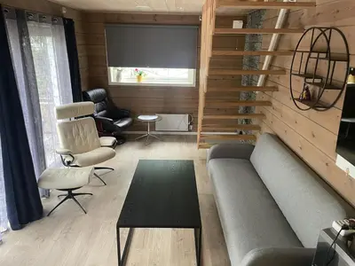 a living room with a couch and a table at Modern holiday home in Ålesund