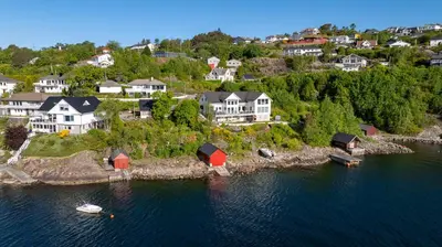 an aerial view of a small island in the water at Beachfront Villa with Jacuzzi, Cinema & Canoe in Bergen