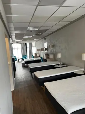 a row of beds in a hospital room at Dokka Motell in Dokka