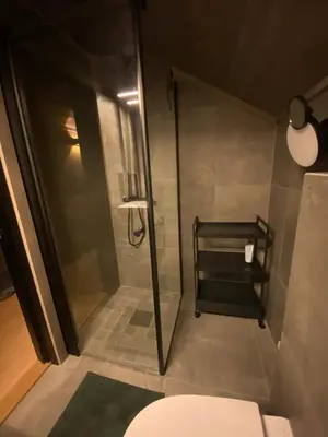 a bathroom with a shower and a toilet at Ski in and ski out in the middle of the slopes in Favang