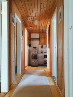 a hallway with wood paneled walls and a wooden ceiling at Nature-Close Cabin In Tranquil Mountain Area in Ulnes