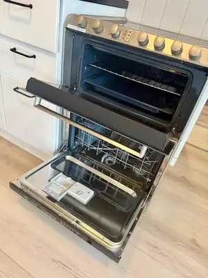 an oven with its door open in a kitchen at Leilighet i under etasje in Lillehammer