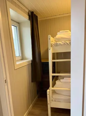 a room with a bunk bed and a window at Leilighet i under etasje in Lillehammer