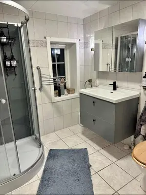a bathroom with a shower and a sink and a mirror at Cozy rooms with private bathroom close to Hønefoss in Knestang