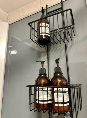three bottles on a shelf in front of a mirror at Cozy rooms with private bathroom close to Hønefoss in Knestang