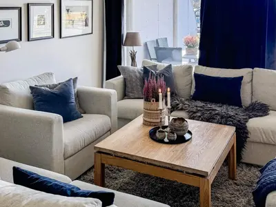 a living room with couches and a table with candles at 4 star holiday home in HOVDEN in Hovden