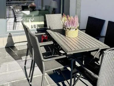 a wooden table with chairs and a vase of flowers on it at 4 star holiday home in HOVDEN in Hovden