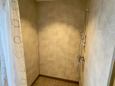 a shower in a bathroom with a shower curtain at 4 star holiday home in Tjeldstø in Tjeldstø