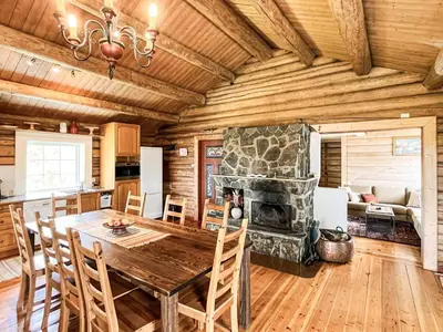 a dining room with a table and a stone fireplace at 4 star holiday home in gol in Gol