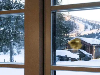 a window with a view of a car in the snow at 8 person holiday home in Hemsedal in Hemsedal