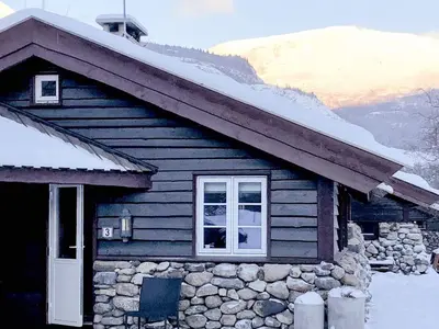 a log cabin with snow on the roof and a window at 8 person holiday home in Hemsedal in Hemsedal
