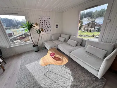 a living room with a couch and a table at 6 person holiday home in KLOKKARVIK in Klokkarvik