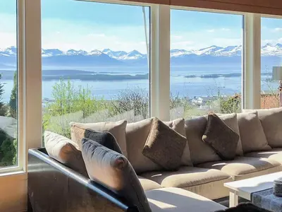 a living room with a couch in front of a large window at 7 person holiday home in Molde in Molde