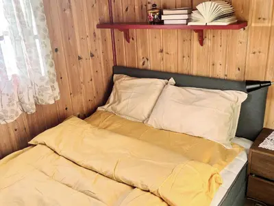 a bed with yellow sheets and pillows in a room at 4 person holiday home in gol in Gol